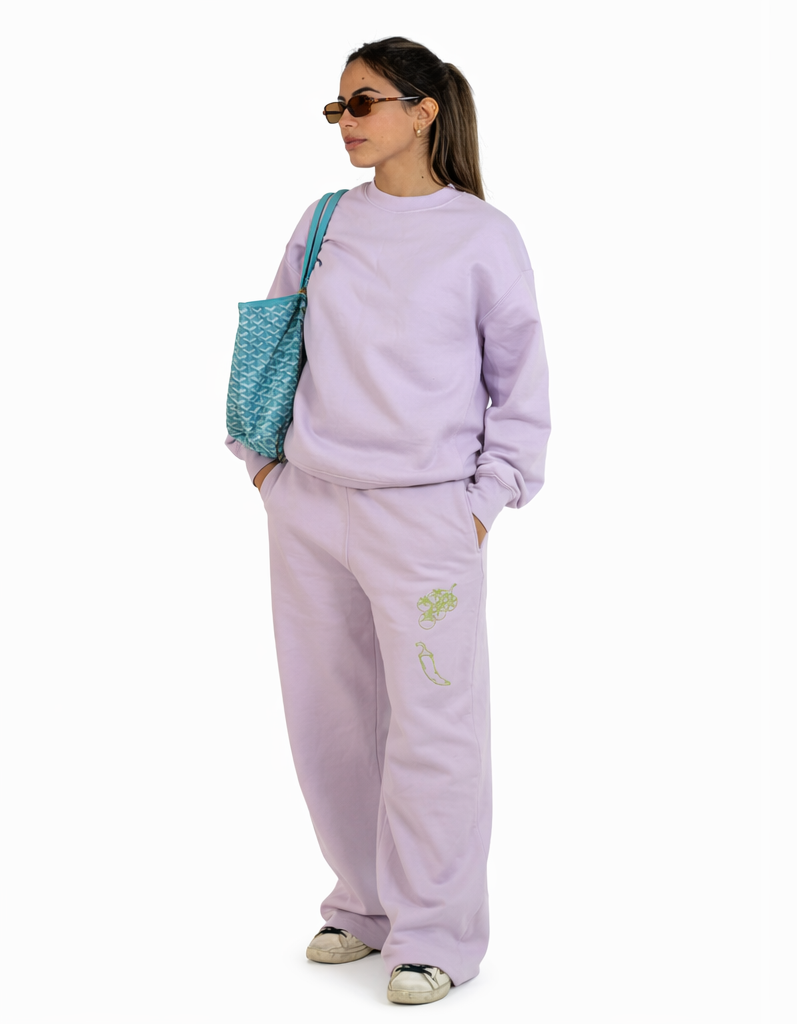Person wearing a lavender tracksuit with a blue bag, shown from front and back on a white background.